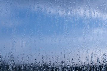 Fototapeta na wymiar Blurred natural water drop window textured glass .