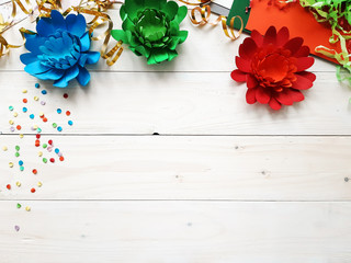 The child made crafts with his own hands. Colorful handmade flowers from multi-colored paper....