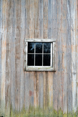 Fototapeta na wymiar weathered wooden wall with window in frame