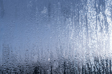 Obraz na płótnie Canvas Blurred natural water drop window textured glass .