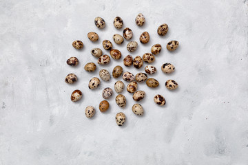 quail eggs on a light background are laid out in the center in a circle