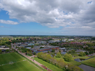 Fototapeta na wymiar Drone Aerial view of soccer fields and the buildings of the village of Grootebroek, which is part of urban planning. Photo make with a drone 