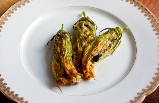 Stuffed zucchini flowers on plate
