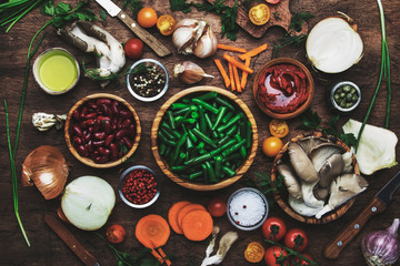 Food cooking background, ingredients for preparation vegan dishes, green bean, vegetables, roots, spices, mushrooms and herbs. Healthy vegetarian food concept.