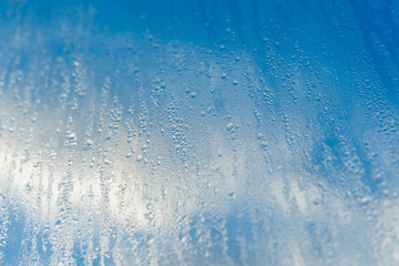 Fototapeta na wymiar Blurred natural water drop window textured glass .