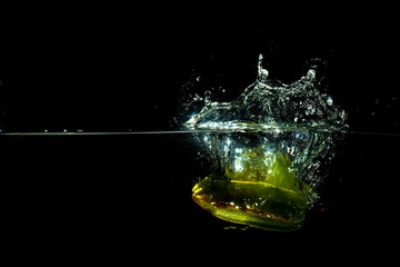 fresh starfruit water splash with black background