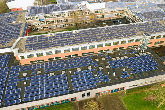 Drone photo of a large school building for vmbo, mavo ,havo and vwo education.n1100 solar panels have been installed on the roof of this school for green energy.