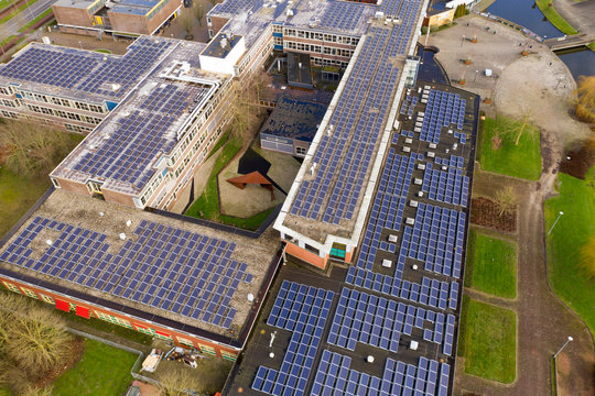 Drone Photo Of A Large School Building For Vmbo, Mavo ,havo And Vwo Education.n1100 Solar Panels Have Been Installed On The Roof Of This School For Green Energy.