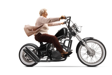 Obraz na płótnie Canvas Grandmother riding a chopper motorbike