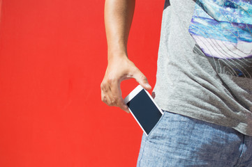 A mobile cell phone in pocket, closeup.