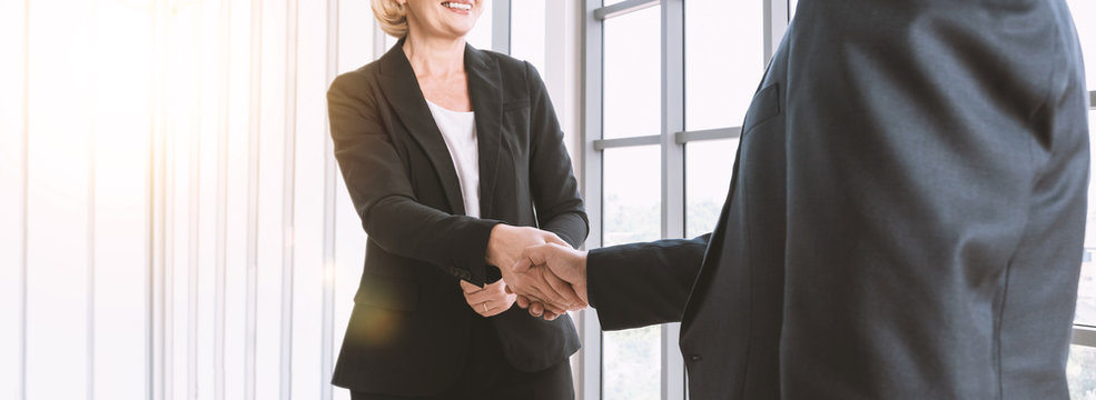 successful negotiate and handshake concept, Businesswoman shaking hands and smiling with parthner to celebration about  contract agreement.