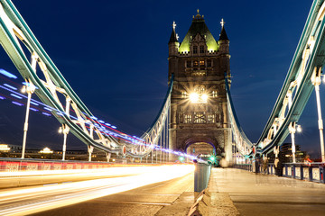 Fototapeta na wymiar Lighted Tower bridge with magical atmosphere in long-exposure mode. Lamps are becoming stars, and time has somehow stopped. Long exposure in London centre on the most famous bridge. Great Britain