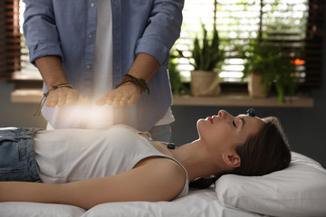 Young woman during crystal healing session in therapy room