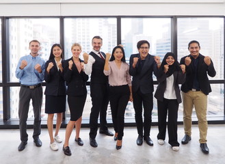 Group of diverse business people standing in the office with city view background feeling happy...