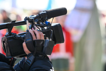 videographer shoots a report on a professional video camera. live broadcast from the scene. coverage of events. journalist camera operator