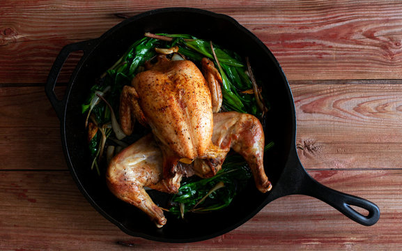 Splayed roast chicken with caramelized ramps, garlic and capers
