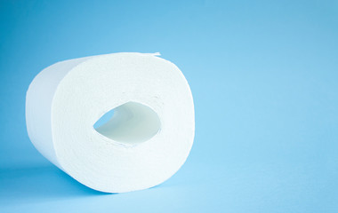 Toilet paper roll on a blue background top view. Toilet paper purchase due to kronavirus concept. Personal hygiene and stopping the spread of the virus. Cleanliness, Hygiene, Sterility copy space