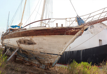 old, rusty ship abandoned on the shore.