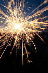 Full-surface burning sparkler creates a warm atmosphere in the evening