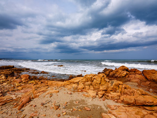 Beach with red porphyry rocks in the immense Mediterranean scrub of Ogliastra, Sardinia, Italy