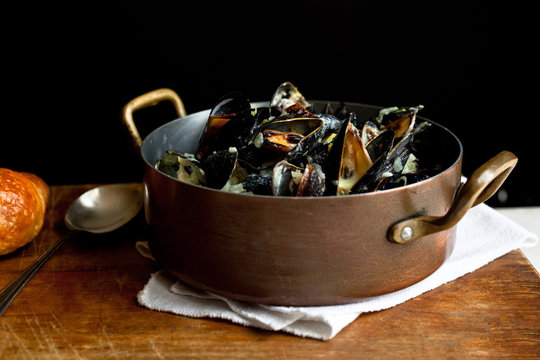 Spicy&dagger;coconut mussels with lemongrass in saucepan