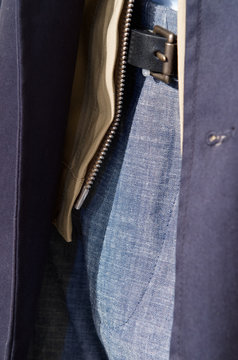 Midsection of man in jacket, belt and pants