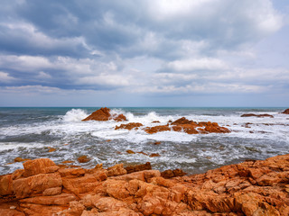 Fototapeta na wymiar Wild and suggestive east coast of Sardinia. Beach with red porphyry rocks in the immense Mediterranean scrub of Ogliastra, Sardinia, Italy