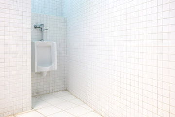 Urinal at the Corner in the White Toilet Room.