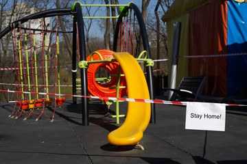 Stay home concept, Red caution tape on kids playground, closed due to COVID-19 quarantine