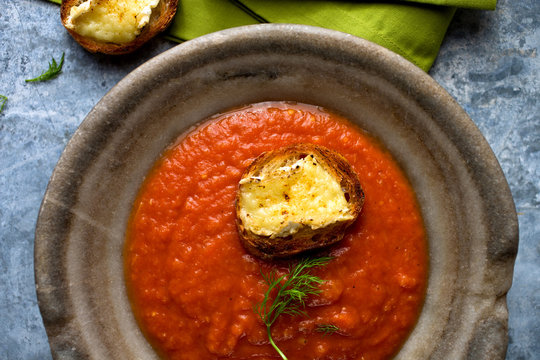 Overhead view of tomato fennel soup with brie toast