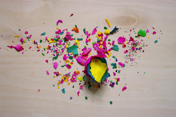 Rainbow rose. A broken flower. Wooden background. Bright color.