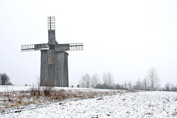 Old wooden wind mill on the countryside.