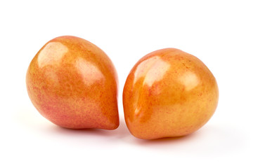 Juicy yellow plums, isolated on white background