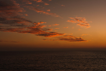 Amazing landscape Beautiful views of a sunset on the beach in front of the sea with clouds orange