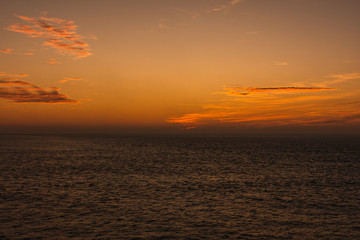 Amazing landscape Beautiful views of a sunset on the beach in front of the sea with clouds orange