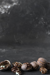 halves of the kernel of a healthy walnut without shell on a dark background, walnut Macro food photo close-up view.