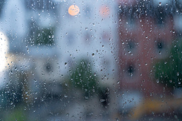 View of the city in rainy weather through the glass