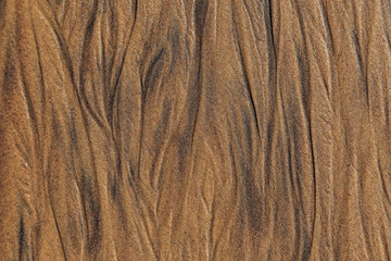 The texture of sea sand with traces of smudges