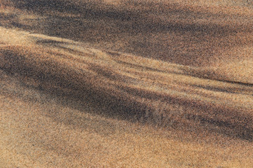 The texture of sea sand with traces of smudges