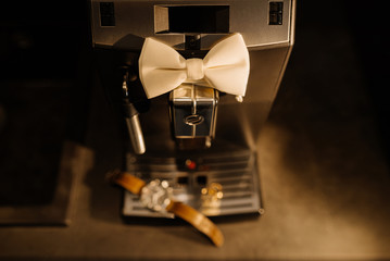 Wedding details. Groom accessories. Coffee machine, watch, rings, and bowtie