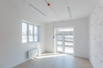 Office extension that uses bricks as a wall, construction, improvement. Interior of small room with window and bricks walls renovation, extension, overhaul and reconstruction.