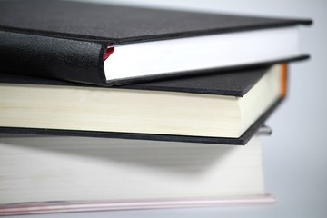 Three stacked books on white background