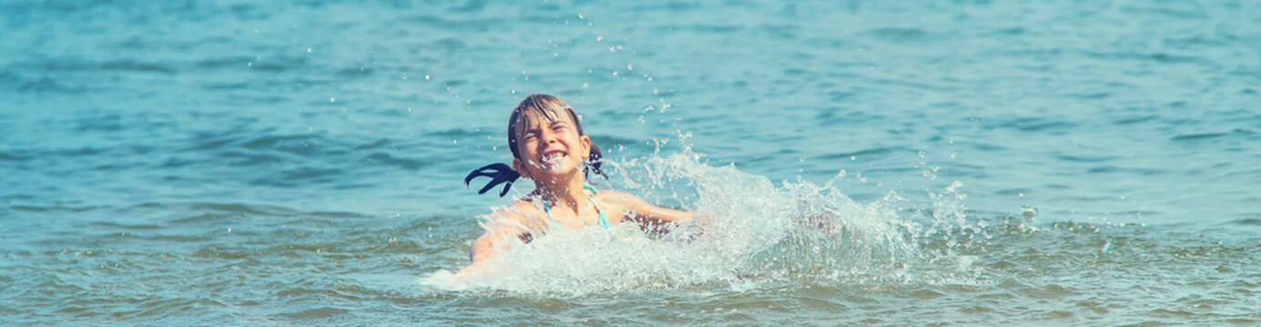 A child drowns in water at sea. Selective focus.