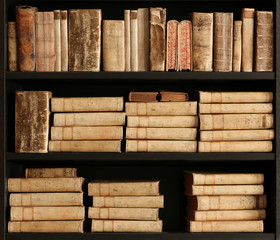 antique books on old wooden shelf.