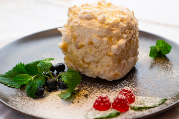 Sweet cake Count ruins on a dark decorated plate with mint leaves with blueberries and marmalades