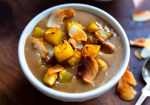 Bowl of Dulce de leche with grilled pineapple and roasted coconut