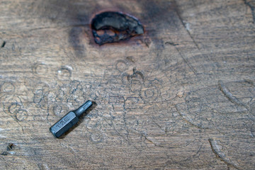 A set of bits for repair. Wooden background.