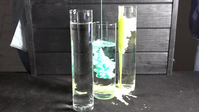 In a transparent container, the colors are mixed with water.