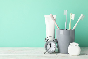 Tools for dental care on mint background, space for text