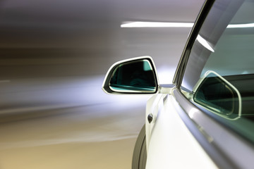 Car light trail while driving in the coty by night